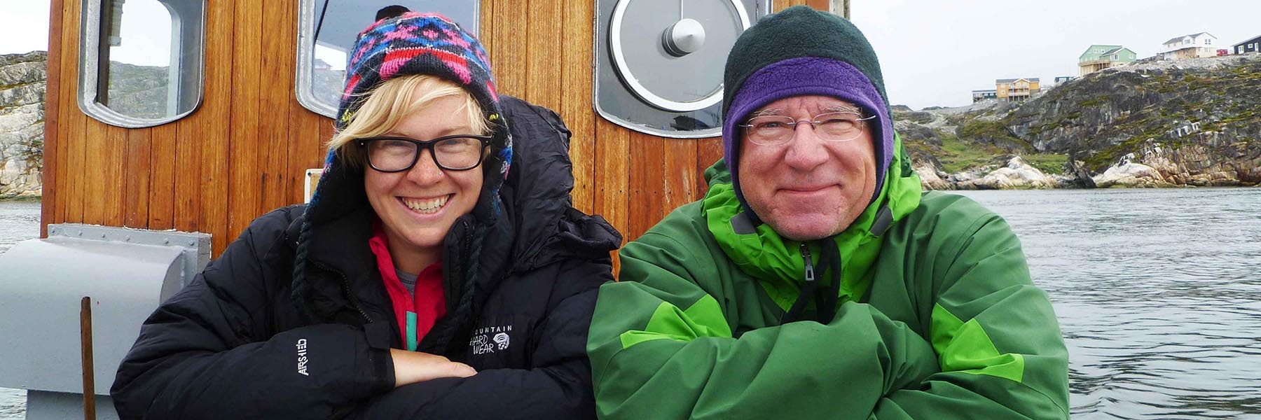 Student and faculty on boat in icy waters.